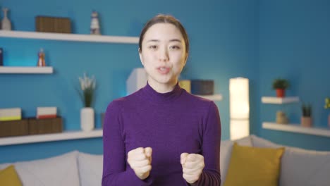 Happy-Asian-woman-giving-speech-towards-camera.
